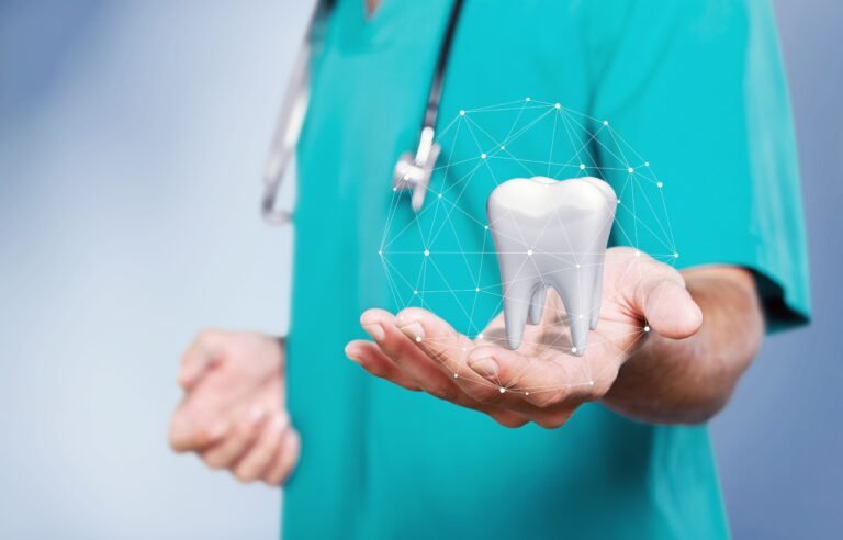 The concept of dental treatment. Doctor shows a tooth in his hand
